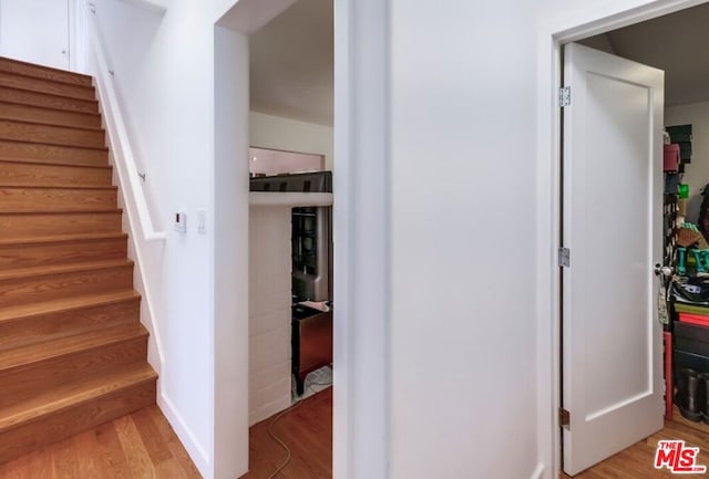 staircase with hardwood / wood-style flooring