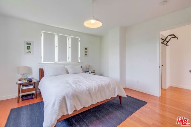 bedroom with hardwood / wood-style floors