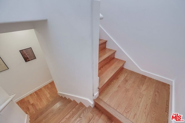 stairs with wood-type flooring