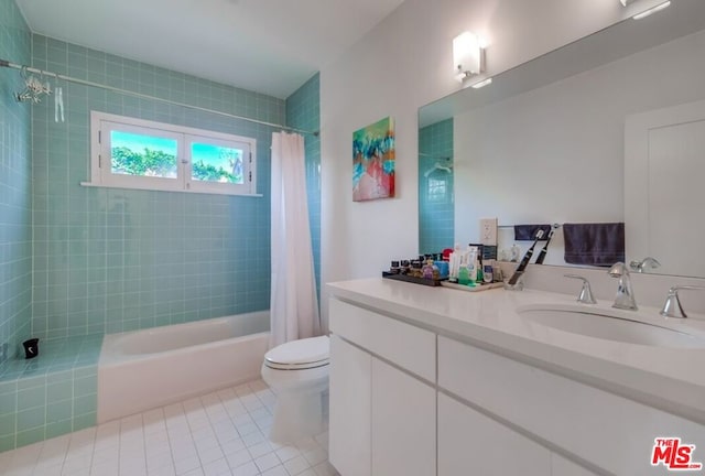 full bathroom featuring tile patterned floors, shower / bath combination with curtain, toilet, and vanity