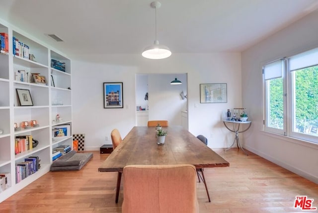 dining space with light hardwood / wood-style flooring