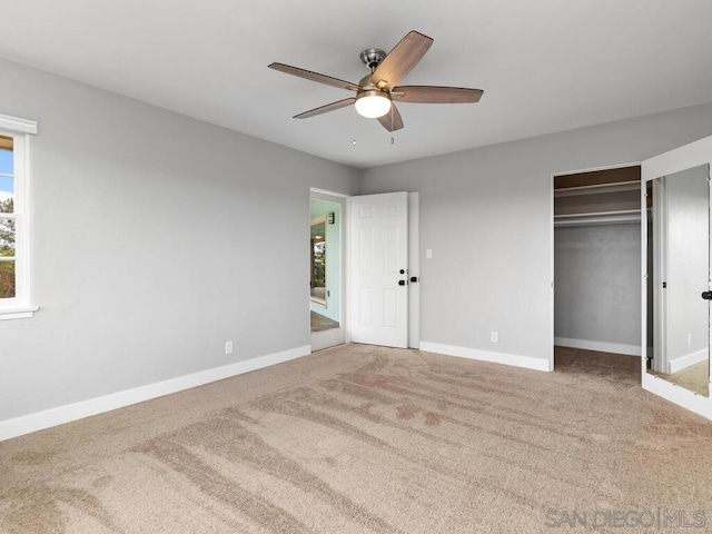 unfurnished bedroom featuring ceiling fan, a closet, and carpet