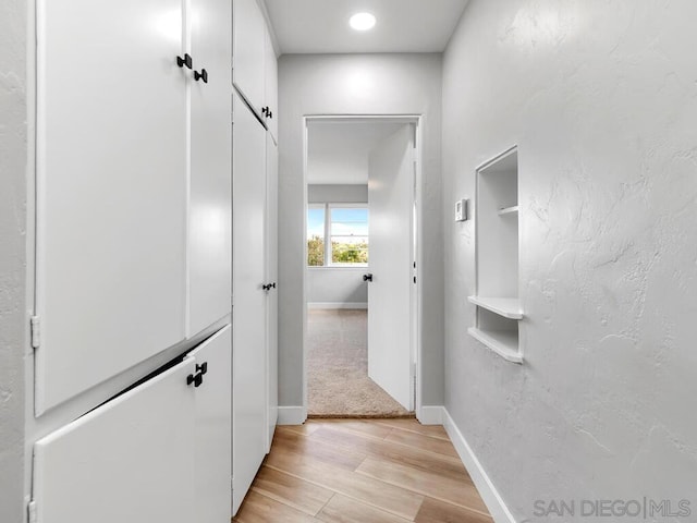 hall with light hardwood / wood-style flooring