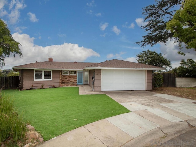 ranch-style home with a garage and a front lawn