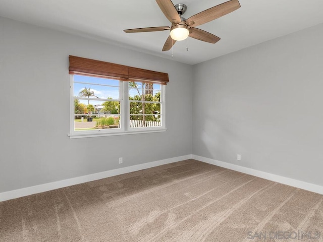 carpeted empty room featuring ceiling fan