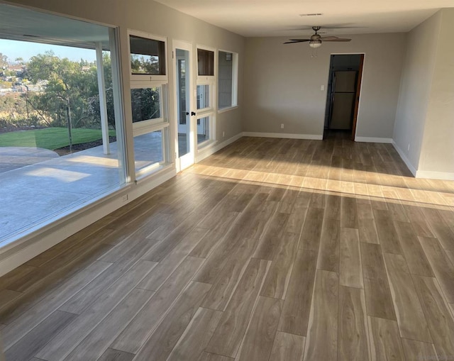 spare room with ceiling fan and wood-type flooring