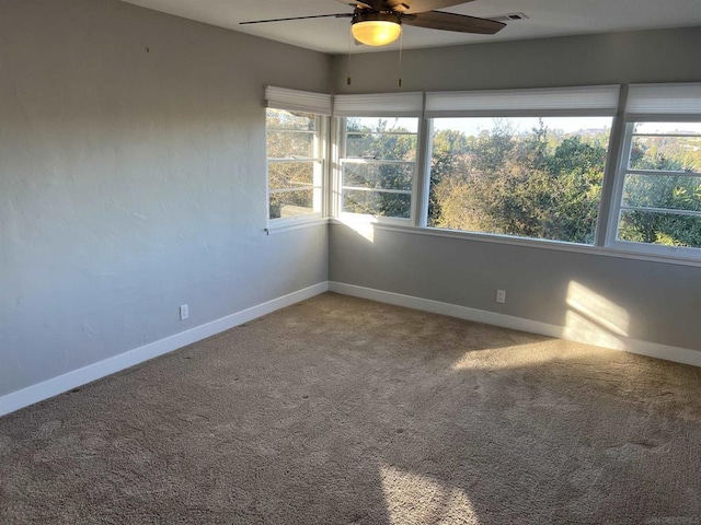 spare room with carpet and ceiling fan