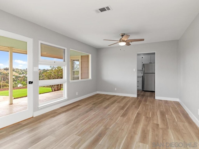 unfurnished room with ceiling fan and light wood-type flooring