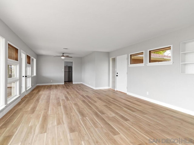 unfurnished living room with light hardwood / wood-style flooring and ceiling fan