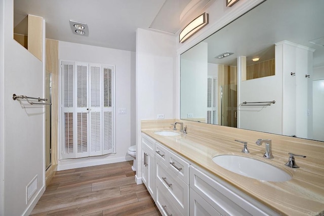 bathroom featuring vanity, toilet, and walk in shower