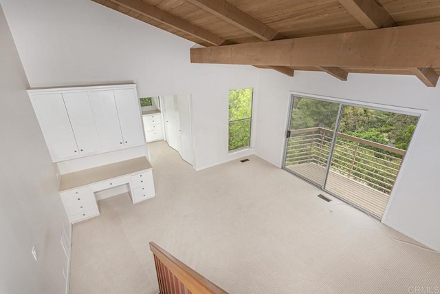 interior space featuring vaulted ceiling with beams, light carpet, and wooden ceiling