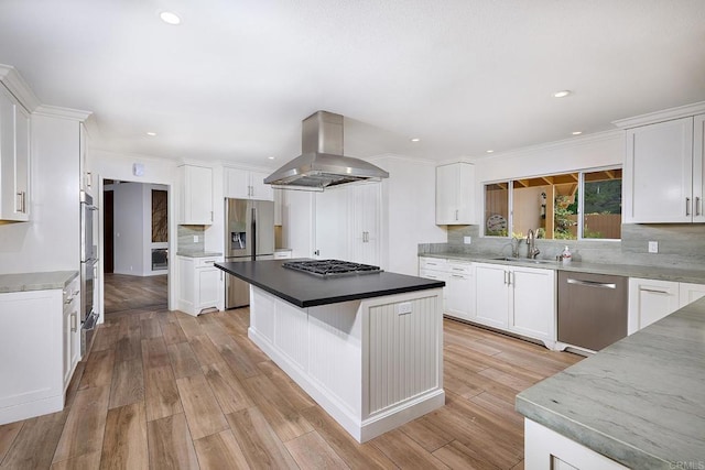 kitchen with a center island, sink, appliances with stainless steel finishes, island range hood, and white cabinetry