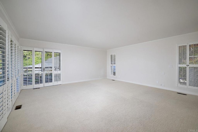 carpeted empty room featuring ornamental molding