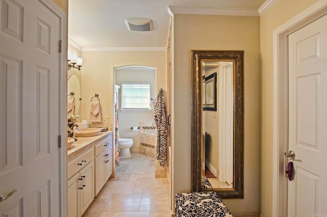 bathroom with tile patterned floors, vanity, ornamental molding, and toilet