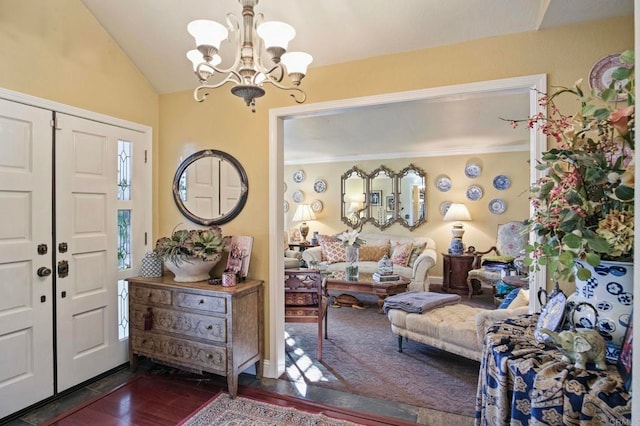 foyer entrance with a notable chandelier, lofted ceiling, and dark wood-type flooring