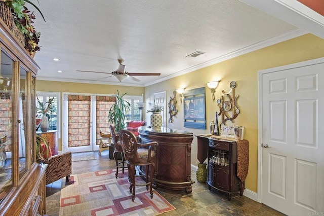 bar featuring ceiling fan and crown molding