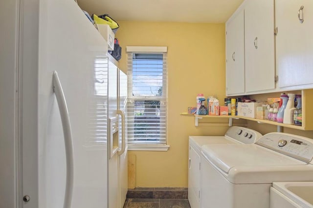 laundry area featuring cabinets, separate washer and dryer, and sink