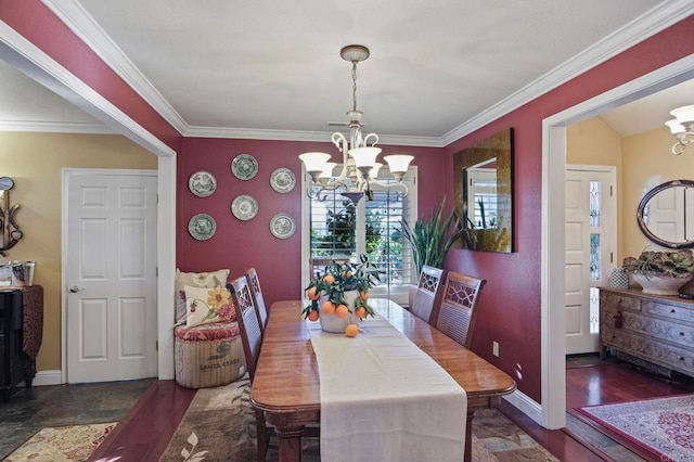 dining room featuring dark hardwood / wood-style flooring, ornamental molding, and a notable chandelier