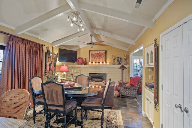 dining space featuring ceiling fan with notable chandelier and lofted ceiling with beams