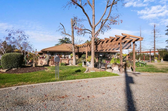 view of front of house with a front yard and a pergola