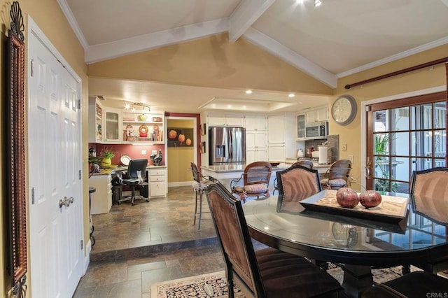 dining room with crown molding and lofted ceiling with beams