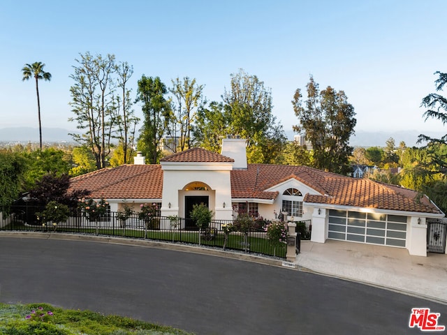 mediterranean / spanish-style house featuring a garage