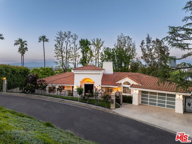 mediterranean / spanish home featuring a garage