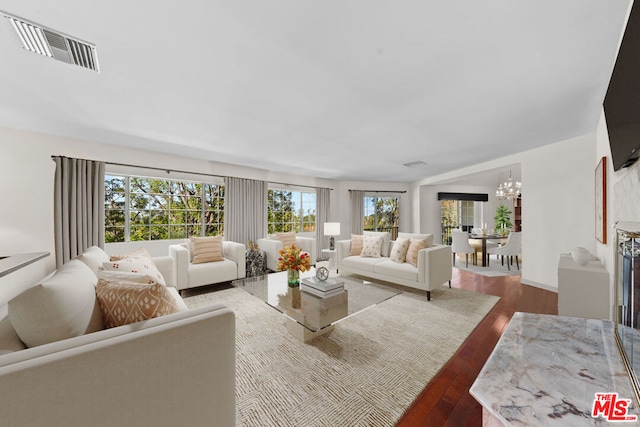 living room with hardwood / wood-style flooring and an inviting chandelier