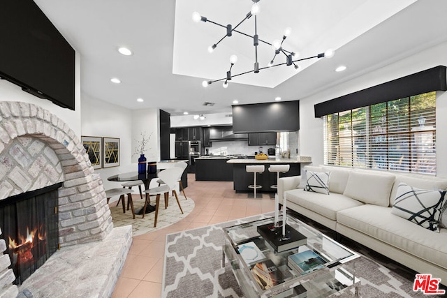 living room with light tile patterned floors and a brick fireplace