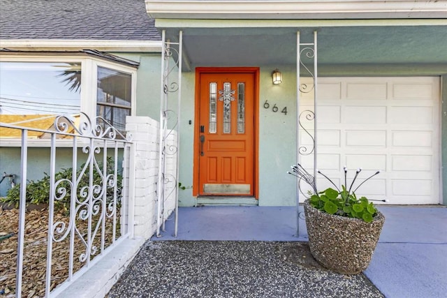 doorway to property with a garage