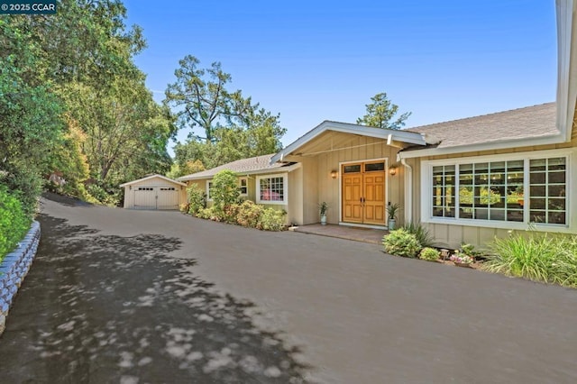 ranch-style home with an outbuilding and a garage