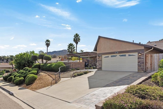 view of front of property with a garage and a mountain view