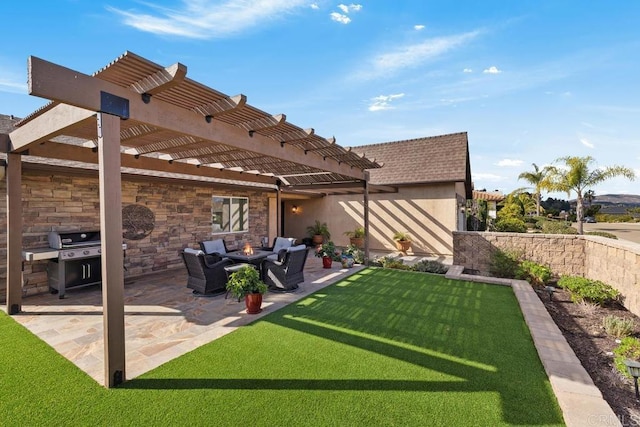 rear view of house featuring a fire pit, a lawn, a pergola, a patio, and an outdoor kitchen