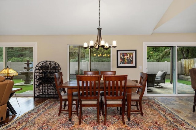 dining room featuring a chandelier and vaulted ceiling