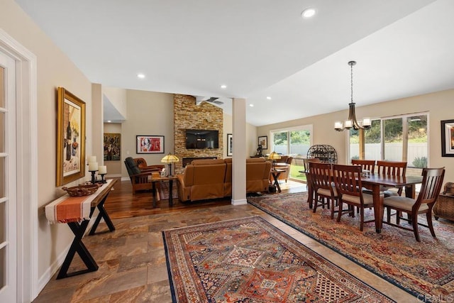 dining space featuring lofted ceiling and a notable chandelier