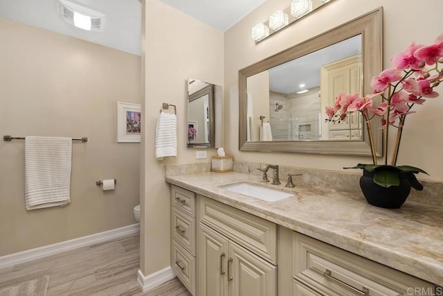 bathroom with vanity, wood-type flooring, toilet, and a shower with shower door