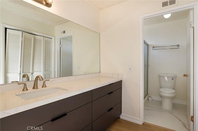 bathroom featuring toilet and vanity