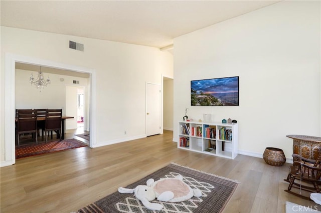 living room with wood-type flooring and a chandelier