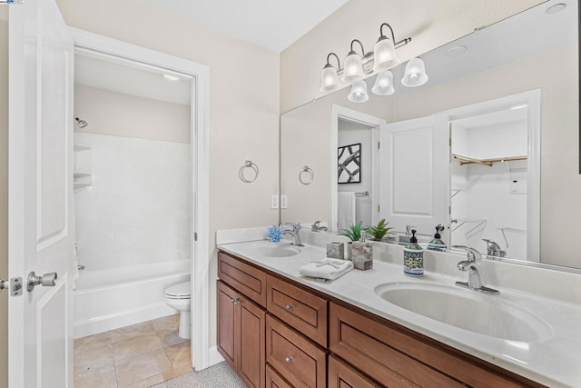 full bathroom featuring washtub / shower combination, vanity, toilet, and tile patterned flooring