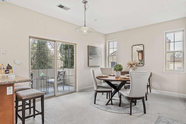 dining area featuring light colored carpet