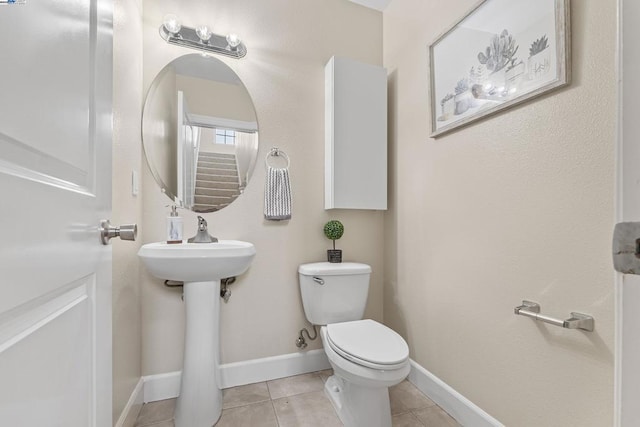 bathroom featuring tile patterned flooring, sink, and toilet