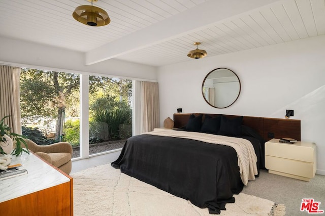 bedroom with access to exterior and beam ceiling