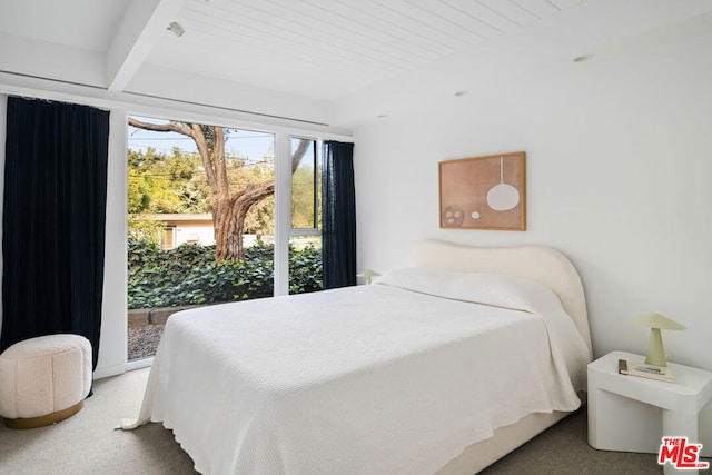 carpeted bedroom featuring beamed ceiling and wood ceiling