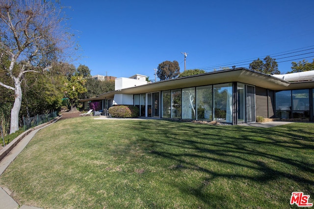 rear view of house with a lawn