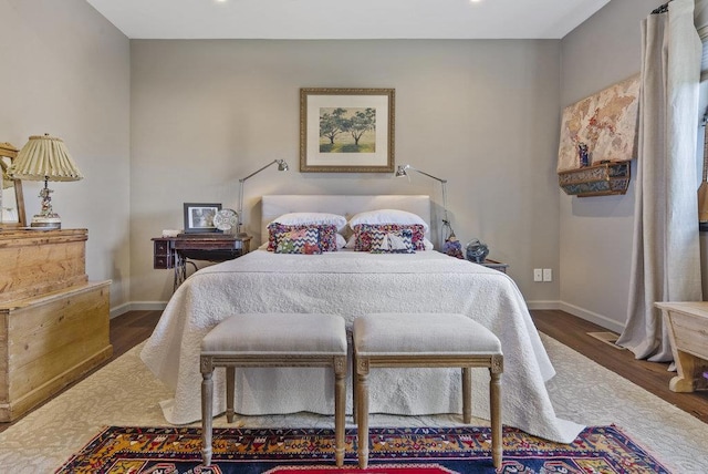 bedroom with dark hardwood / wood-style flooring