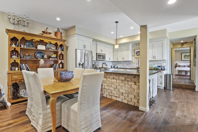 dining space with dark hardwood / wood-style flooring