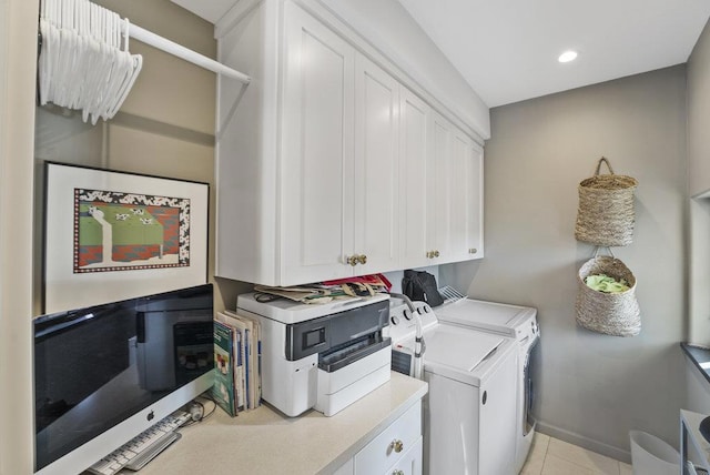 laundry room with cabinets, light tile patterned floors, and washing machine and clothes dryer