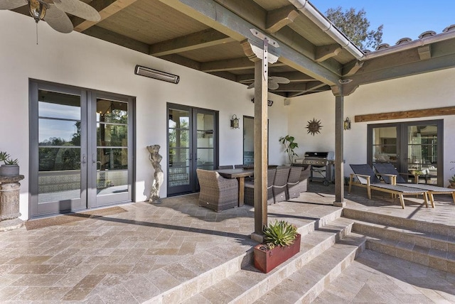 view of patio with ceiling fan, area for grilling, and french doors