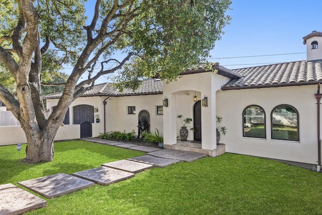 mediterranean / spanish home with a front yard