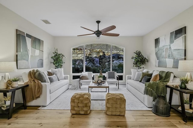 living room with ceiling fan and light hardwood / wood-style flooring